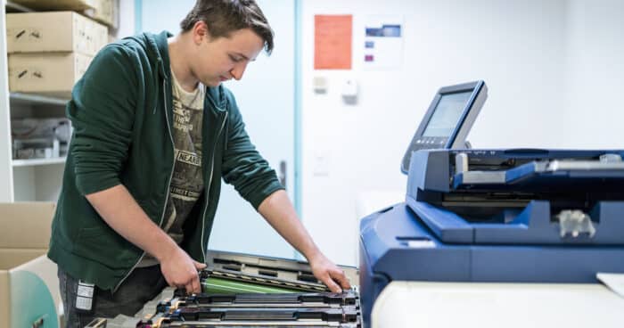 teenager working at color printer