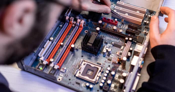 cropped image of man fixing motherboard