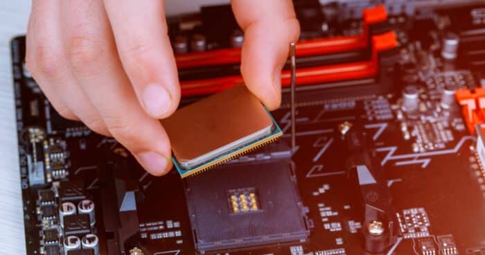 the technician is putting the cpu on the socket of the computer motherboard. the concept of computer hardware, repairing,