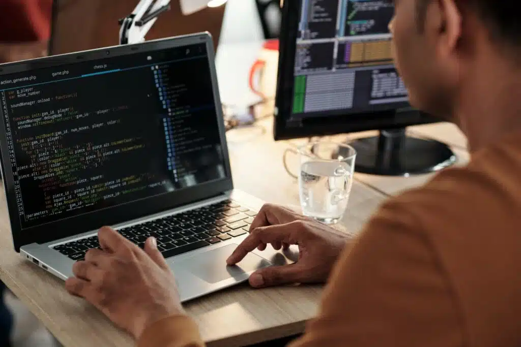 software developer coding on laptop